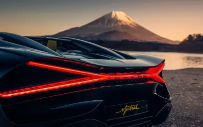 The W16 Mistral’s X-shaped taillights illuminate with intensity as dusk sets across Japan.