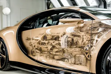 26 sketches on the passenger’s side outline the landmark Bugatti moments from 1909 to 1956 including icons like the Type 41 Royale and the Type 57 SC Atlantic.  
